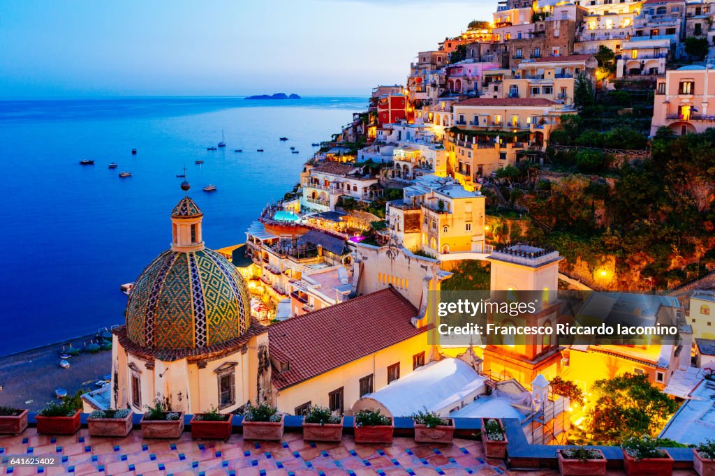 Positano, Amalfi Coast, Campania, Sorrento, Italy. View of the town and the seaside in a summer sunset