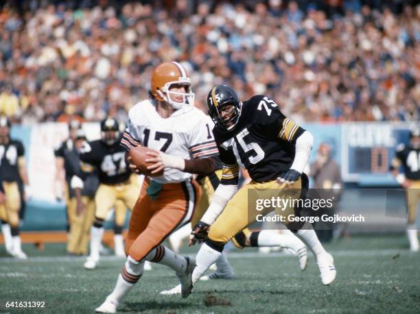 Defensive lineman Joe Greene of the Pittsburgh Steelers pursues quarterback Brian Sipe of the Cleveland Browns during a game at Cleveland Municipal...