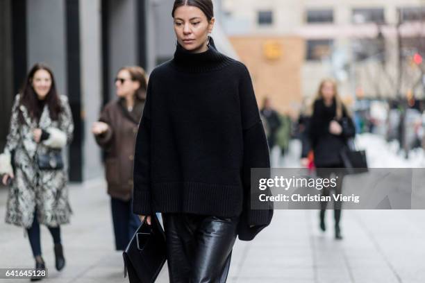 Guest wearing black knit, leather pants outside Creatures of the Wind on February 11, 2017 in New York City.