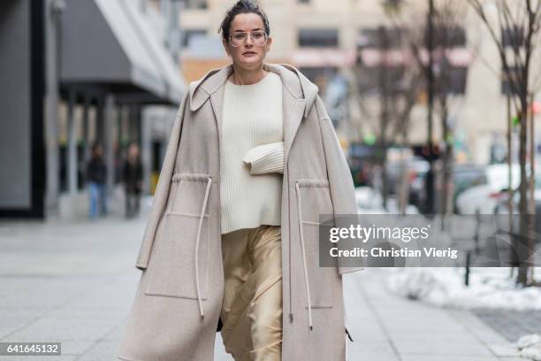 Guest wearing a creme coat, knit, beige pants outside Creatures of the Wind on February 11, 2017 in New York City.