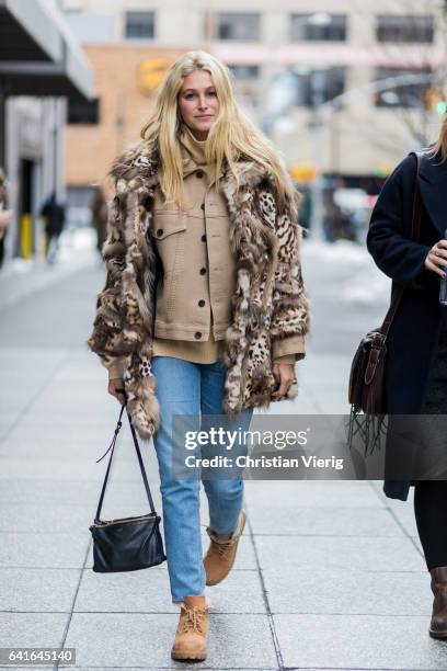 Guest wearing a fur coat, denim jeans outside Creatures of the Wind on February 11, 2017 in New York City.