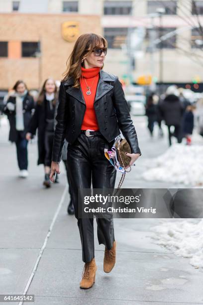 Ece Sukan wearing orange turtleneck knit, black leather jacket, black leather pants outside Creatures of the Wind on February 11, 2017 in New York...
