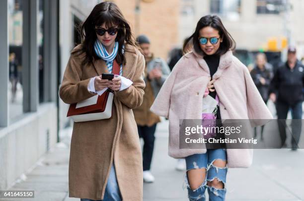 Guests wearing a beige coat, pink coat outside Creatures of the Wind on February 11, 2017 in New York City.