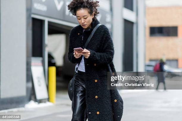 Guest wearing a black wool coat, leather pants outside Creatures of the Wind on February 11, 2017 in New York City.