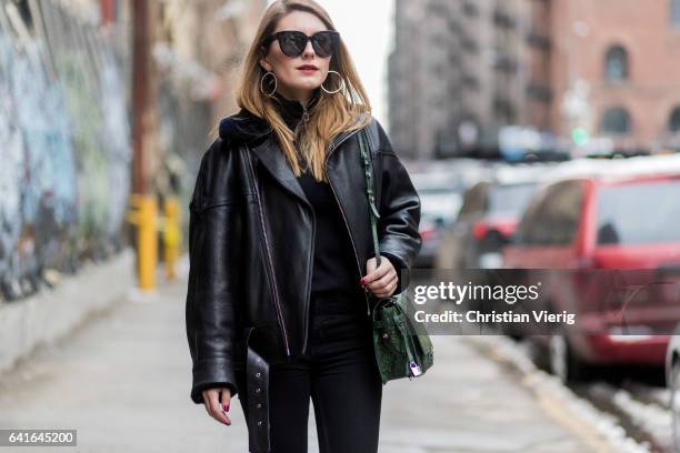 Magdalena Isic wearing Loeil shoes, Zadig & Voltaire bag, Topshop leather jacket and denim jeans, Celine sunglasses outside Tibi on February 11, 2017...