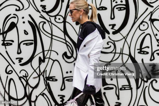 Celine Aargaard wearing a Vetements hoody, white jacket, Loewe bag, vinyl pants outside Tibi on February 11, 2017 in New York City.