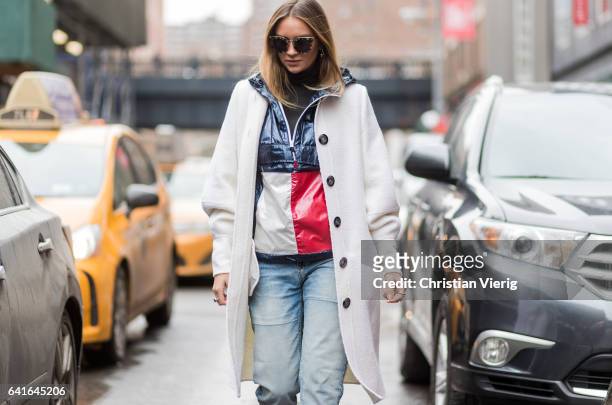 Nina Suess wearing a Tommy Hilfiger jacket, Oscar de la Rente coat, Scotch & Soda denim, Saint Laurent shoes outside Tibi on February 11, 2017 in New...