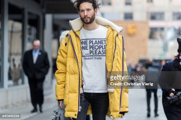 Isaac Hindin-Miller wearing a yellow parka, white tshirt outside Creatures of the Wind on February 11, 2017 in New York City.