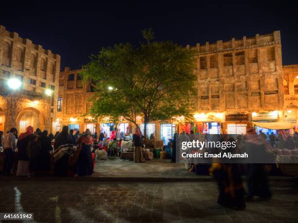 qatari women gather nightly on one corner of souq waqif making and selling traditional food and bread, souq qaqif, qatar - doha people stock pictures, royalty-free photos & images