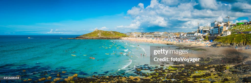 Surfers and sunbathers on sandy beach St Ives panorama Cornwall