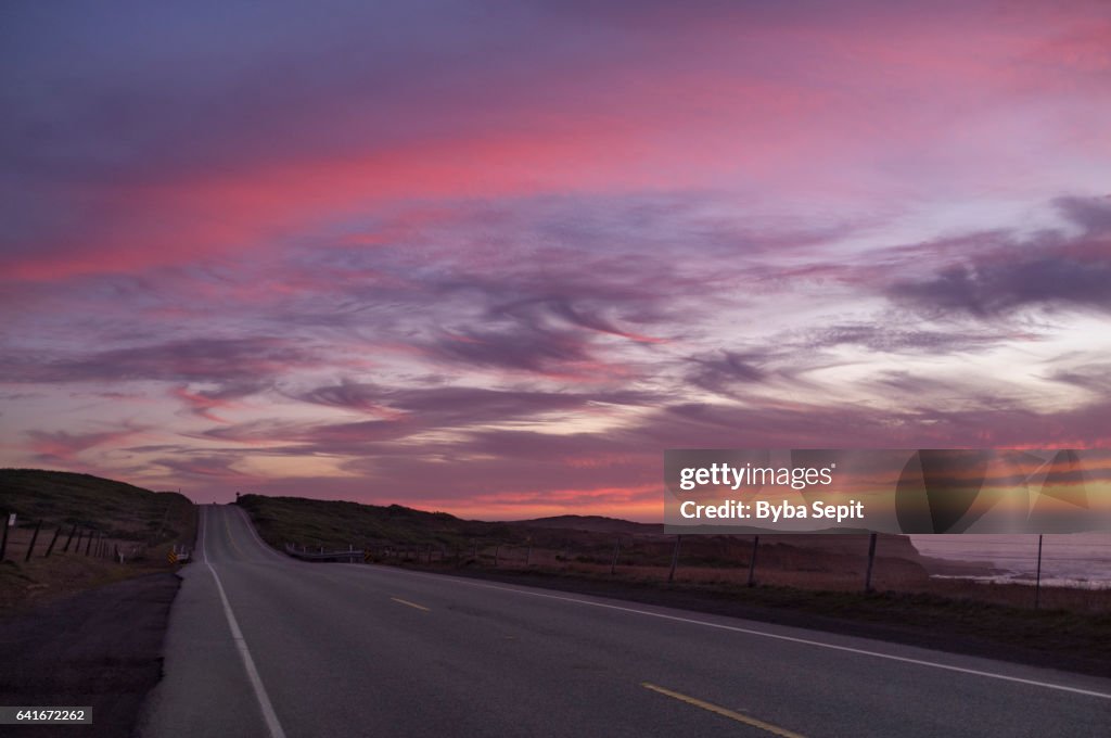 Twilight Sky Full of Magenta Clouds over a Road