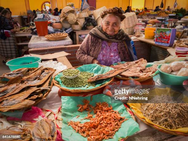 zapotec woman selling dried seafood in market - oaxaca stock pictures, royalty-free photos & images