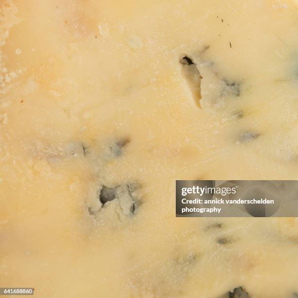 close-up piece of stilton cheese. - blue cheese crumble stock pictures, royalty-free photos & images