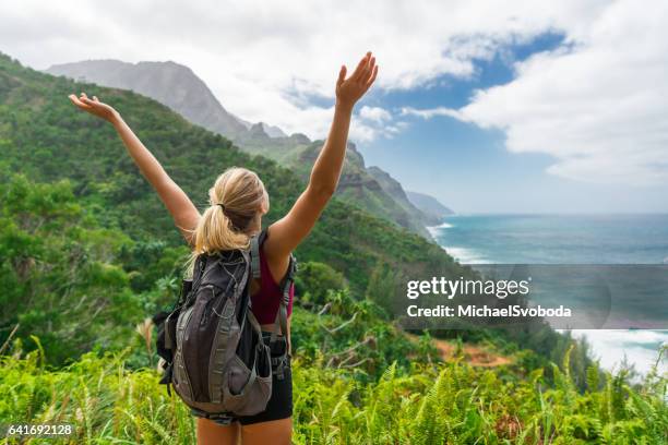 hiker celebrating the beauty - kauai ocean stock pictures, royalty-free photos & images