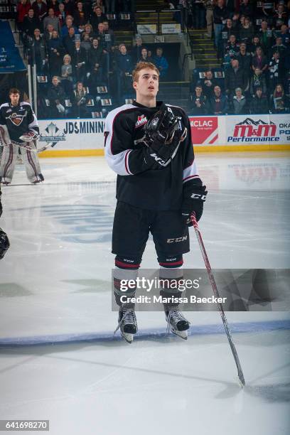 Ty Ronning of the Vancouver Giants stands on the blue line holding his helmet during the national anthem against the Kelowna Rockets on February 10,...