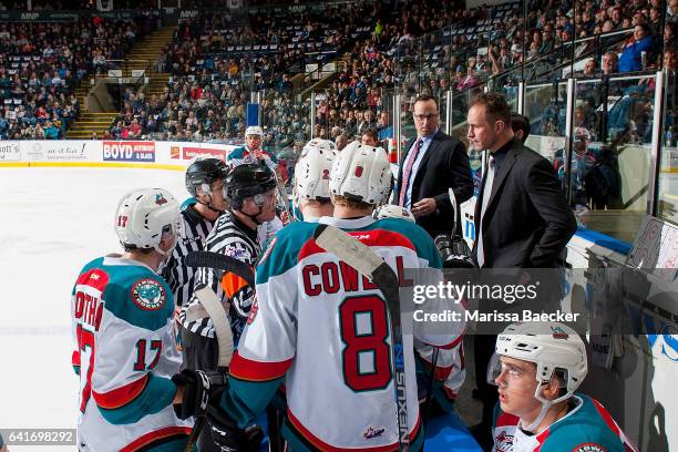 Kelowna Rockets' coaches Kris Mallette and Jason Smith stand on the bench speaking to referee Ward Pateman and linesman Dustin Minty against the...