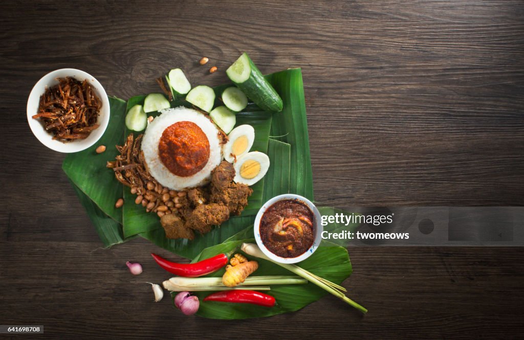 Malaysia traditional food "Nasi lemak" and ingredients on rustic wooden table top.