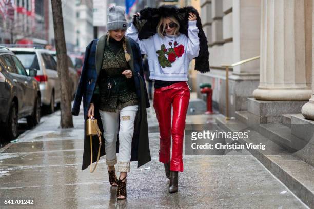 Nina Suess wearing a navy checked coat, grey beanie, white pants, heels and Lisa Hahnbueck wearing 0611 Fur Jacket, Off White Rose Embroidered and...