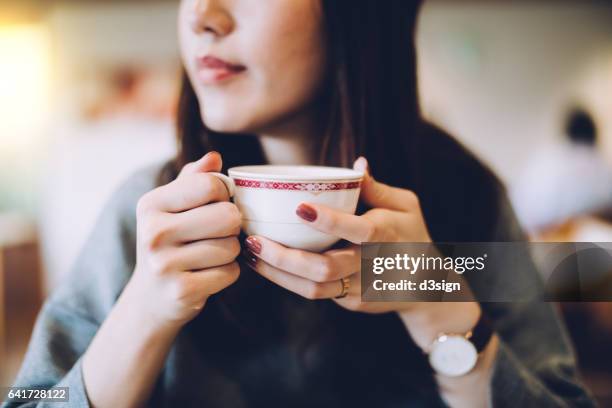 smiling woman enjoying coffee - 喫茶店 ストックフォトと画像