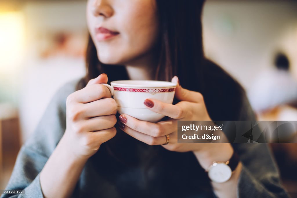 Smiling woman enjoying coffee