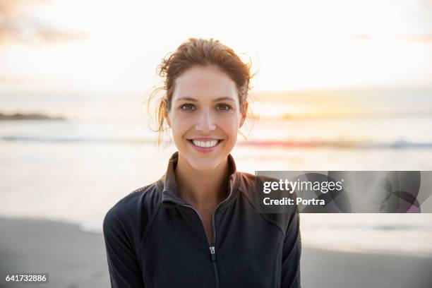 happy female athlete at beach during sunset - nature focus on foreground stock pictures, royalty-free photos & images