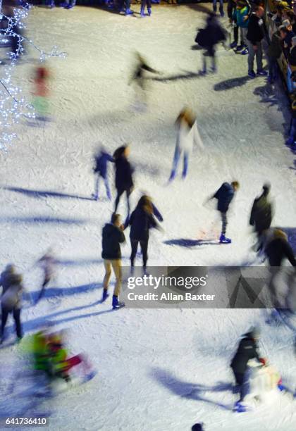 ice skaters on rink at night in bruges main square - national day of belgium 2016 imagens e fotografias de stock