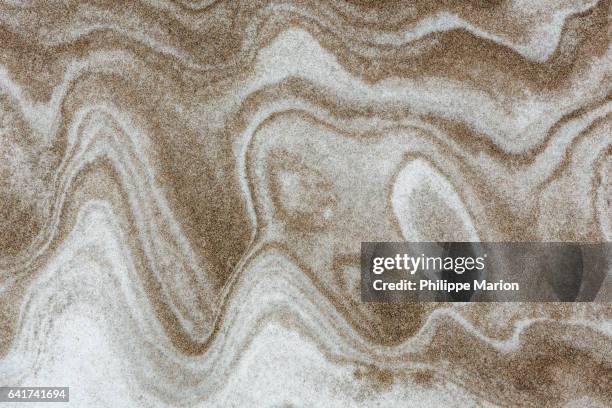 winter patterns of beach sand and snow on lake ontario beach, canada - lake ontario stock pictures, royalty-free photos & images