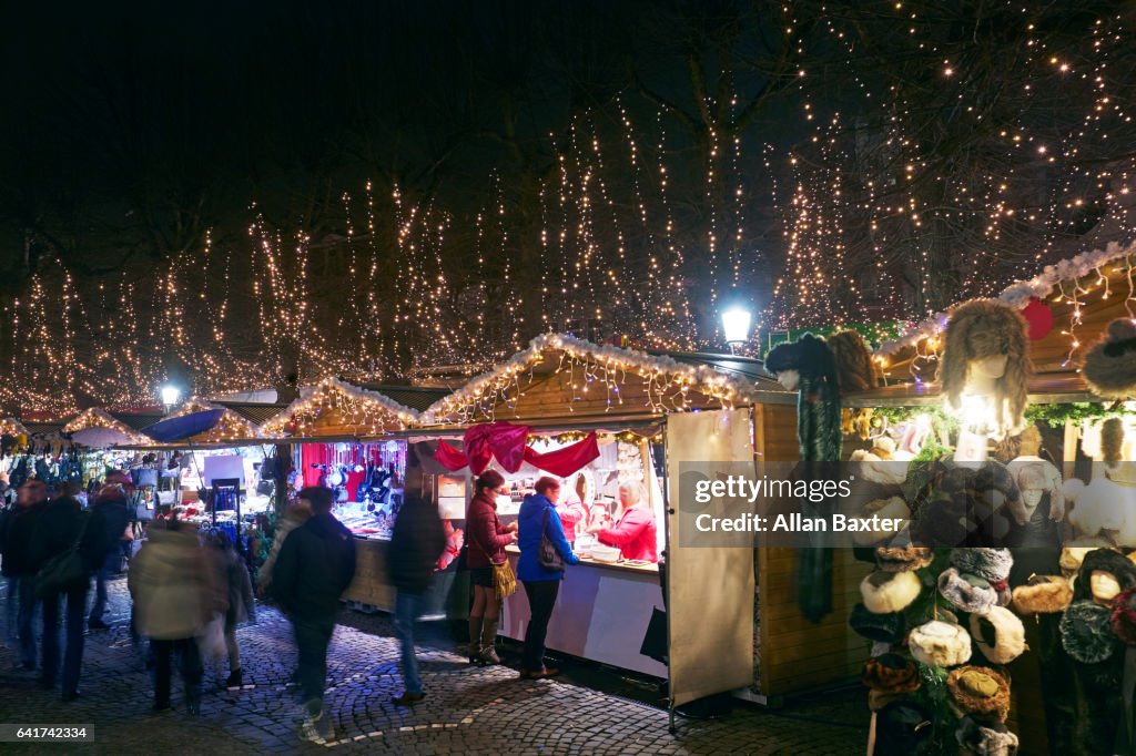 Christmas Market with shoppers in Bruges at night