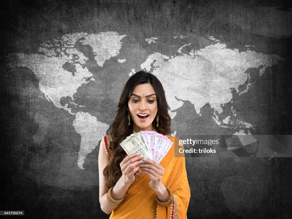 Woman holding Indian paper currency