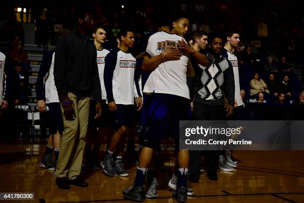 Matt Howard hugs Tyler Hamilton of the Pennsylvania Quakers the first half at The Palestra on February 12, 2017 in Philadelphia, Pennsylvania. The...