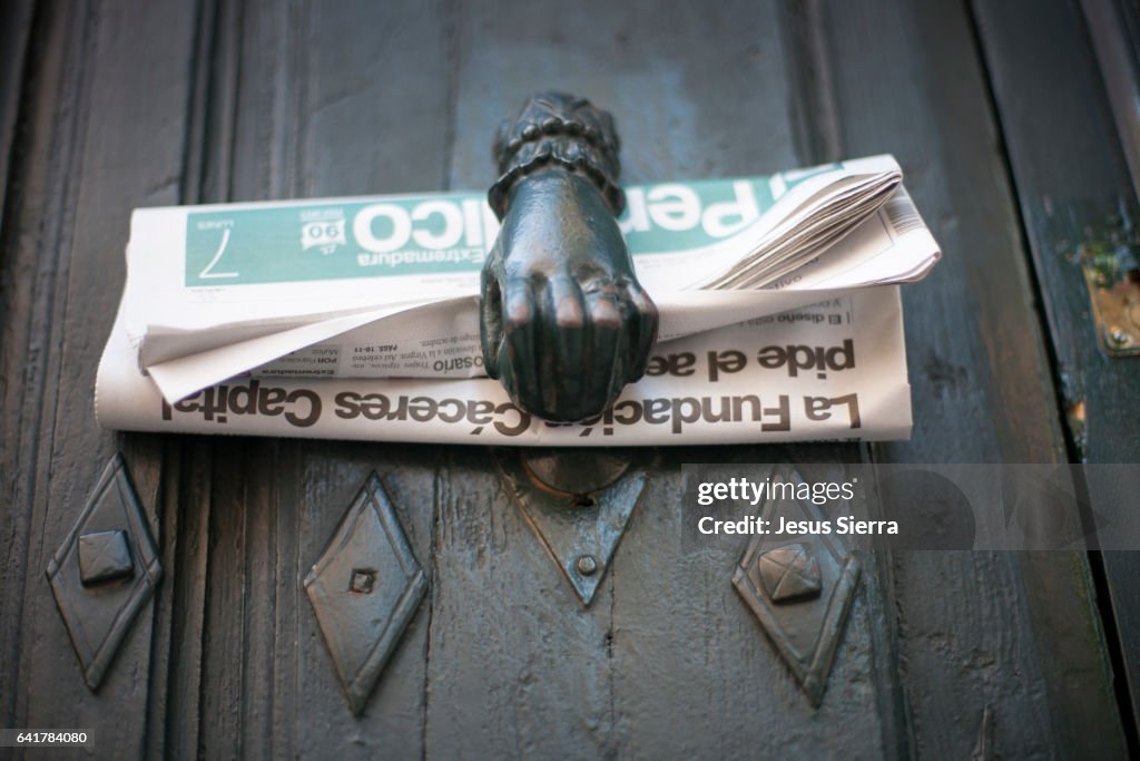 Newspaper on the door of a house in Caceres