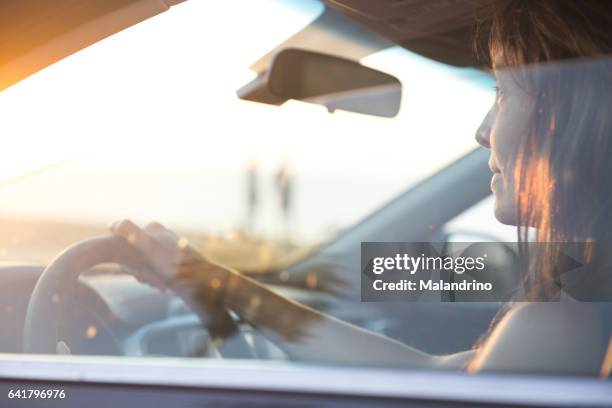 woman driving a car - steuern stock-fotos und bilder