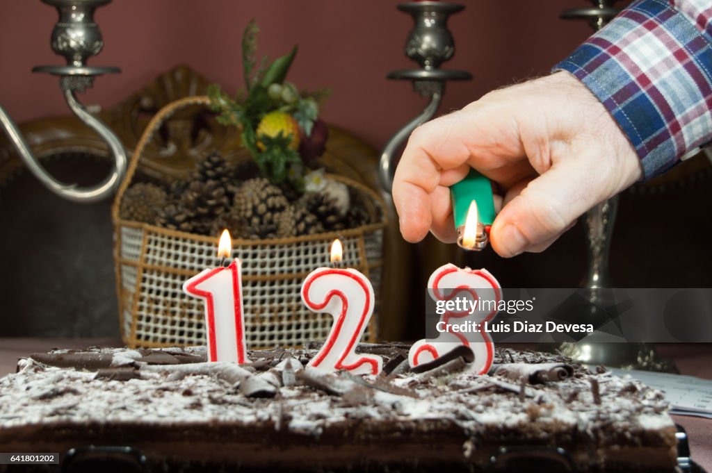 Man burning candles with a lighter