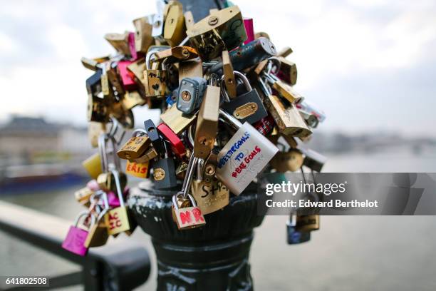 Love Padlocks” are seen on Floor lamps at Le Pont Des Arts on February 12, 2017 in Paris, France. The Ponts des Arts was overweight with 'Love...