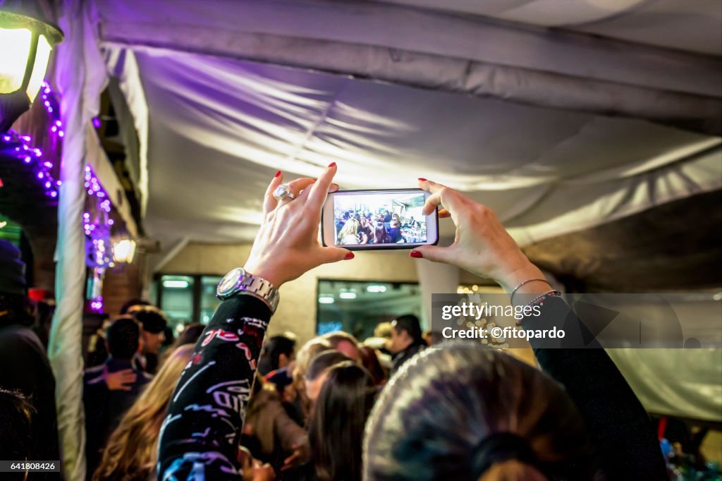 Woman using her digital camera to take a photo