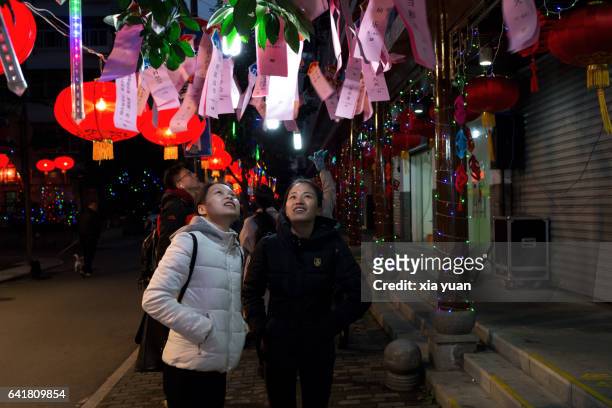 two girls guessing riddles on the lantern festival parade,hangzhou,china - china lantern stock pictures, royalty-free photos & images