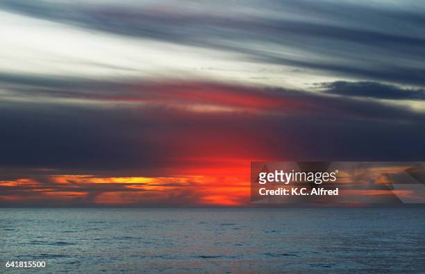 the sun sets at windansea beach in the la jolla area of san diego, california. - la jolla stock-fotos und bilder