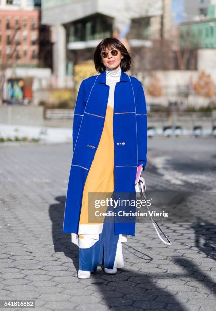Guest wearing a blue coat outside 3.1 Phillip Lim on February 13, 2017 in New York City.