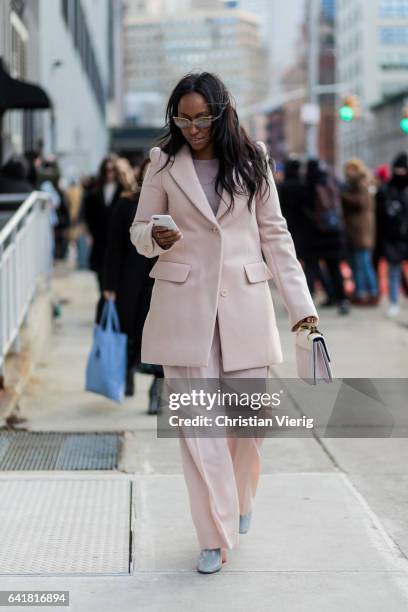 Shiona Turini wearing a salmon coloured suit outside 3.1 Phillip Lim on February 13, 2017 in New York City.