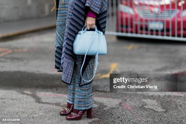 Natalie Joos wearing a cape outside 3.1 Phillip Lim on February 13, 2017 in New York City.