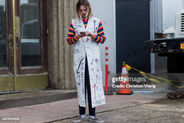 Guest wearing a sleevless printed coat outside 3.1 Phillip Lim on February 13, 2017 in New York City.