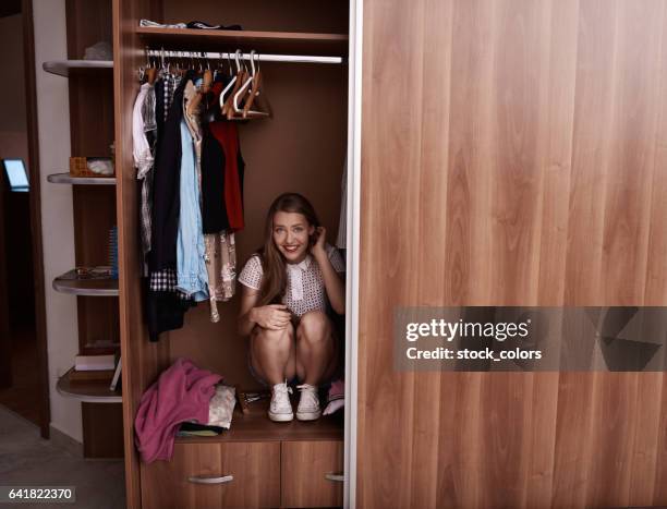 hiding in the wardrobe - open romania imagens e fotografias de stock