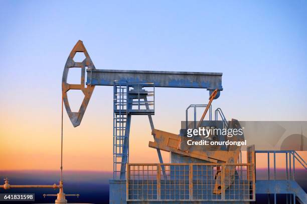 pumpjack silhouettes - pump jack stock pictures, royalty-free photos & images