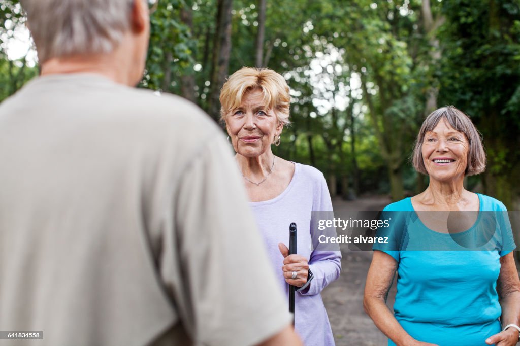 Fitness instructor with senior people in park