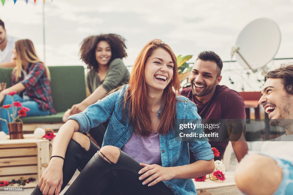 Multi-ethnic group of friends chatting and laughing