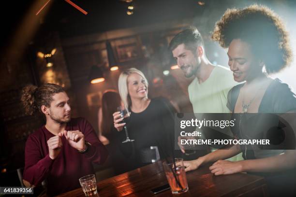 group of people in the bar - whisky bar stock pictures, royalty-free photos & images