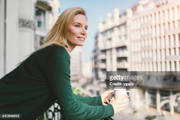 single woman on hotel balcony - hotel balcony stock pictures, royalty-free photos & images