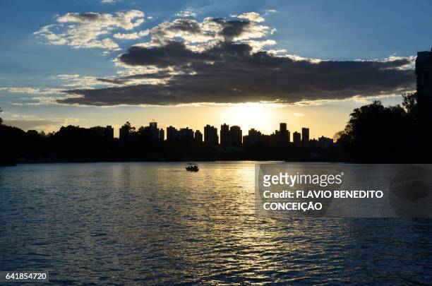 sunset with lake view and silhouette of the building - silhueta urbana stock-fotos und bilder