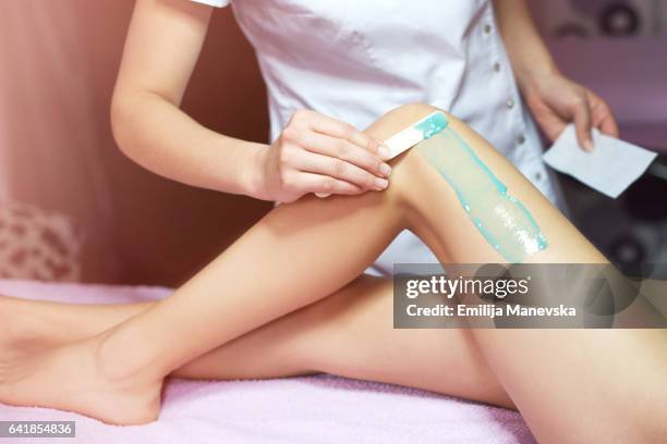 woman receiving wax hair removal - hars stockfoto's en -beelden