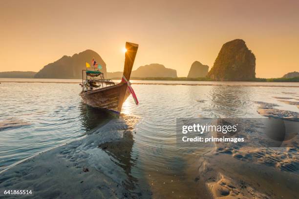 beautiful sunset at tropical sea with long tail boat in south thailand - phuket stock pictures, royalty-free photos & images